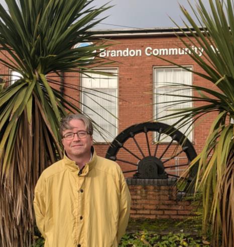 Jonathan Elmer standing in front of Brandon Community Hall